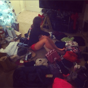Me sitting in the middle of a pile of clothes before a ski trip