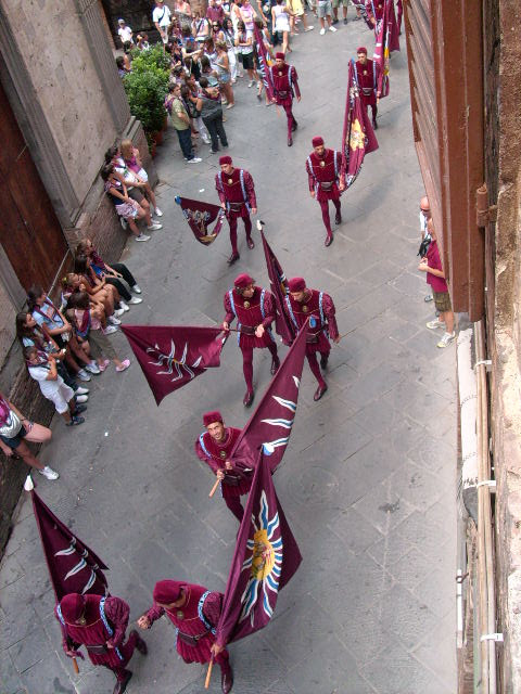 A parade as part of a contrada festival in Siena. This one is called Torre.